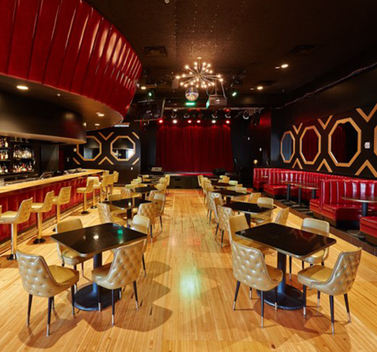 Corporate team singing karaoke during a fun team building night out in Austin Texas